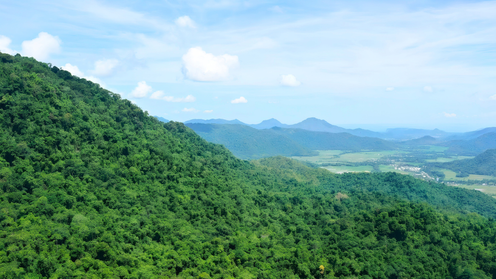 Comparison of Greenfield and Brownfield exploration projects showing a remote exploration site with geological surveys and an established mining area with resource expansion drilling in Indonesia