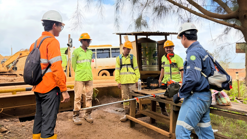 Geophysical exploration team conducting Drone Magnetic and CSAMT surveys with field geologists analyzing subsurface data before exploration drilling at a mineral exploration site in Indonesia